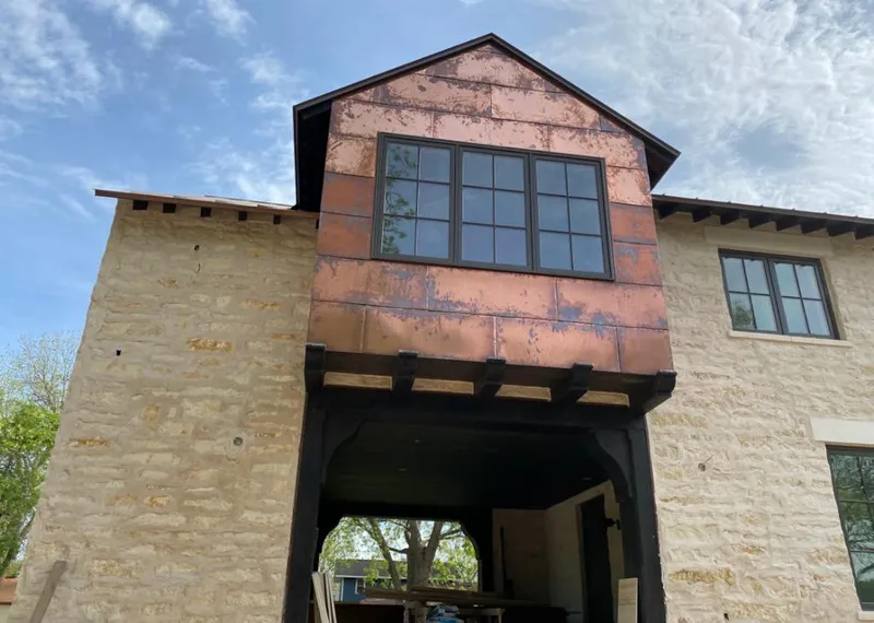 Copper metal panel facade on a stone building for Roof Repair in Raleigh Hills