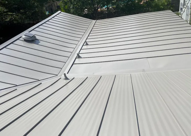 Solar attic fan installed on a metal roof for Roof Ventilation in Raleigh Hills